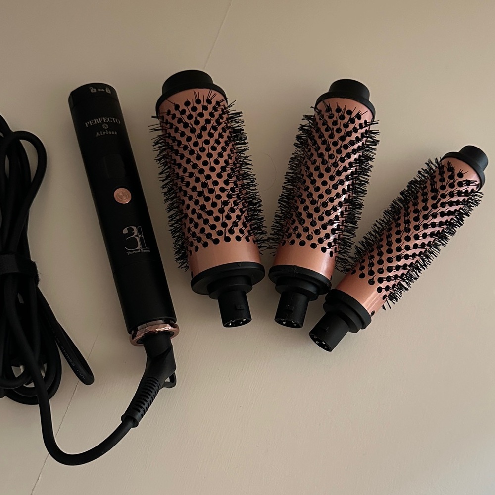 Thermal Brush heated hair curler with three attachments.